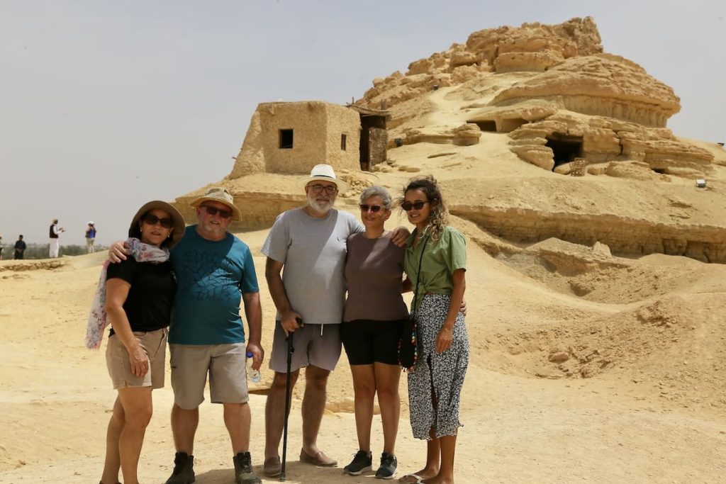 A family of four posing in front of the ancient ruins at Siwa Oasis, Egypt.