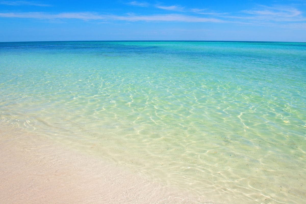 Crystal-clear turquoise waters along the sandy beach of Marsa Matruh, Egypt.