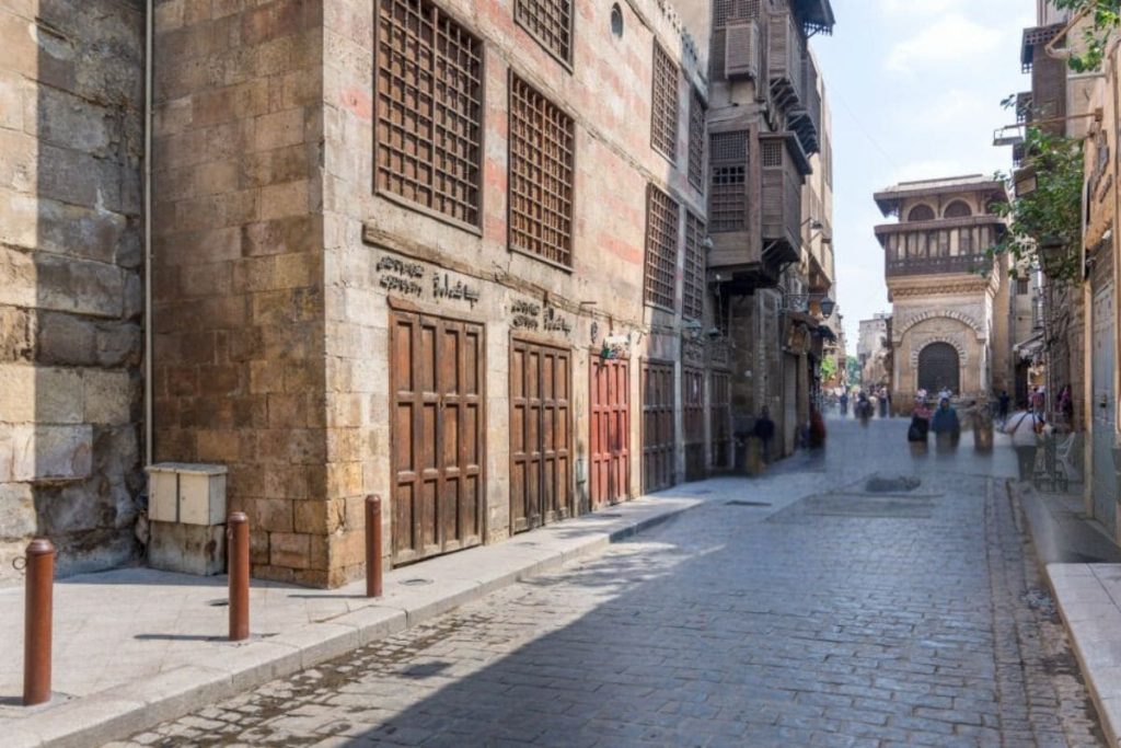 Charming historic street in Cairo with traditional buildings and a lively atmosphere