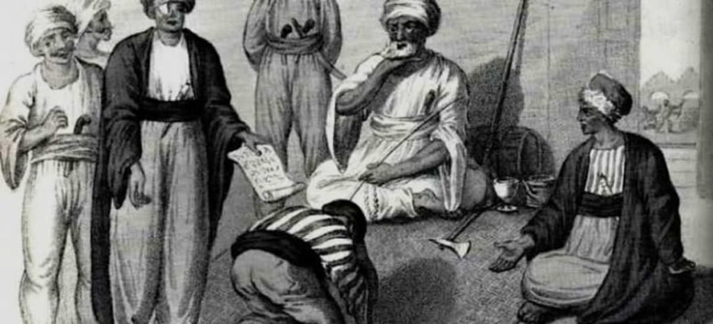 Black and white illustration of a traditional gathering in the Middle East, depicting men in historical attire engaging in a discussion, one holding a document.