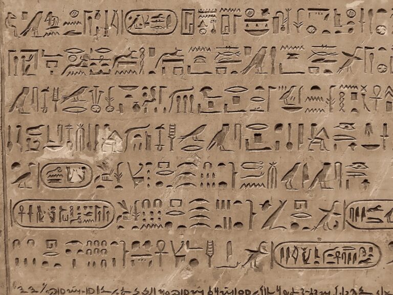 Detailed view of ancient hieroglyphic carvings on a stone surface in Saqqara, Egypt.