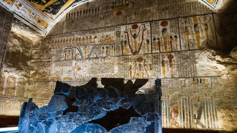 Wall paintings depicting ancient Egyptian gods inside a tomb in the Valley of the Kings, Luxor, Egypt.