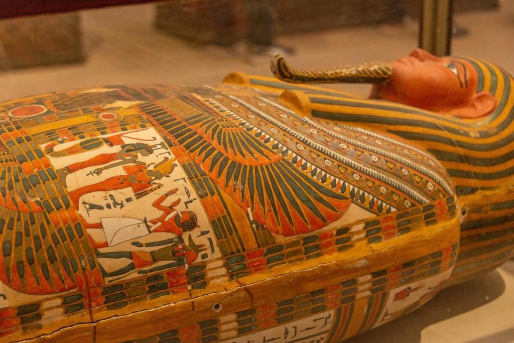 A colorful ancient Egyptian sarcophagus with detailed artwork.