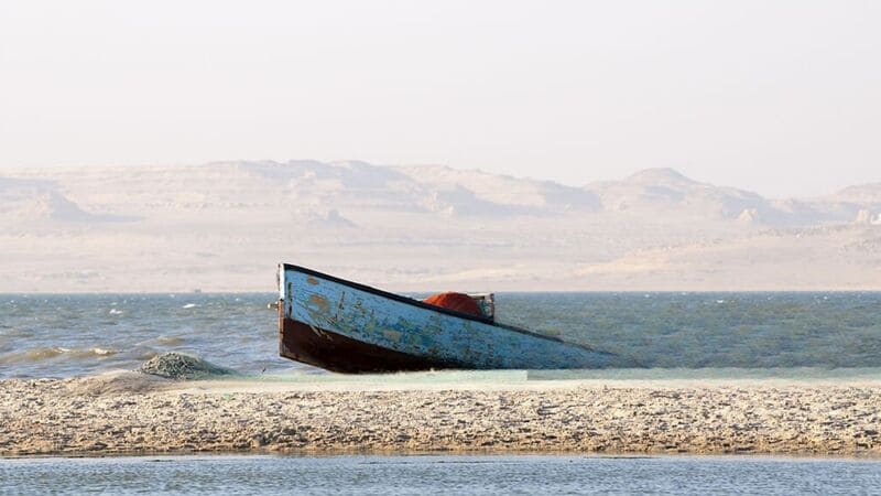 Traditional boat sailing on the tranquil waters of Fayoum Oasis, Egypt