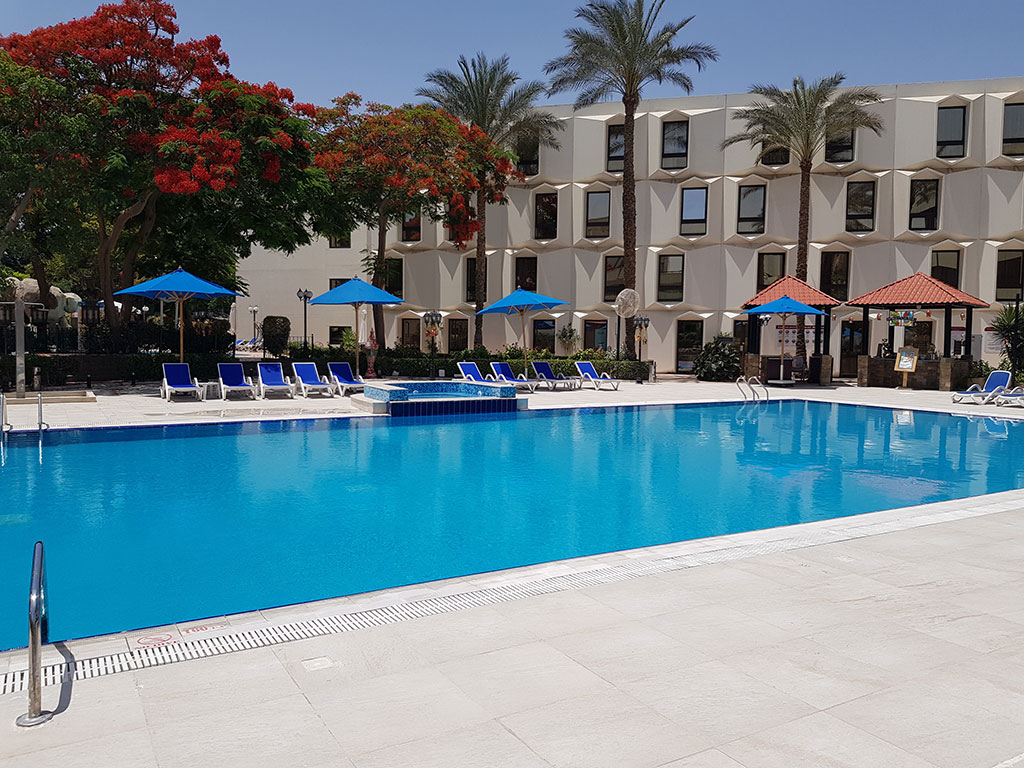 Le Passage Cairo Hotel with a luxurious pool area and lush garden surroundings