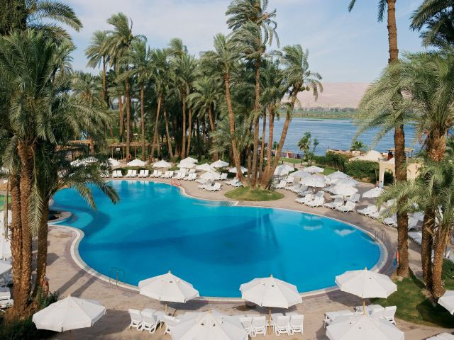 Mercure Luxor Karnak Resort with a luxurious pool area and lush palm trees