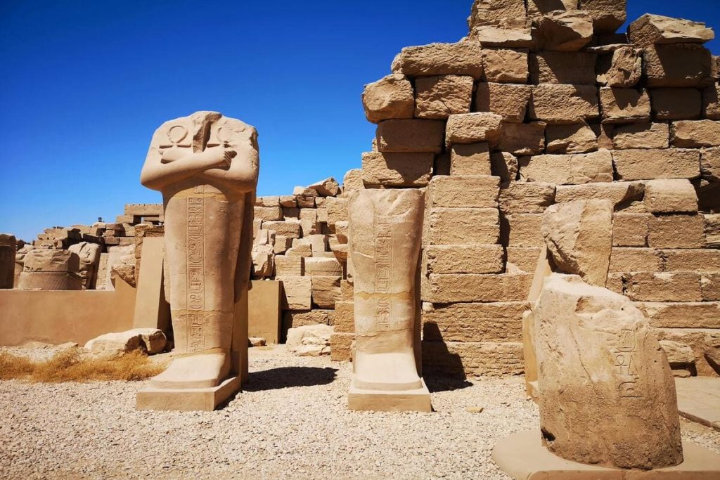 Avenue of Sphinxes leading to the Karnak Temple in Egypt, lined with rows of majestic stone sphinxes under a clear blue sky