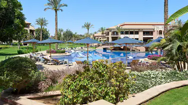 Luxurious outdoor pool area at The Westin Cairo Golf Resort & Spa with palm trees and lounge chairs