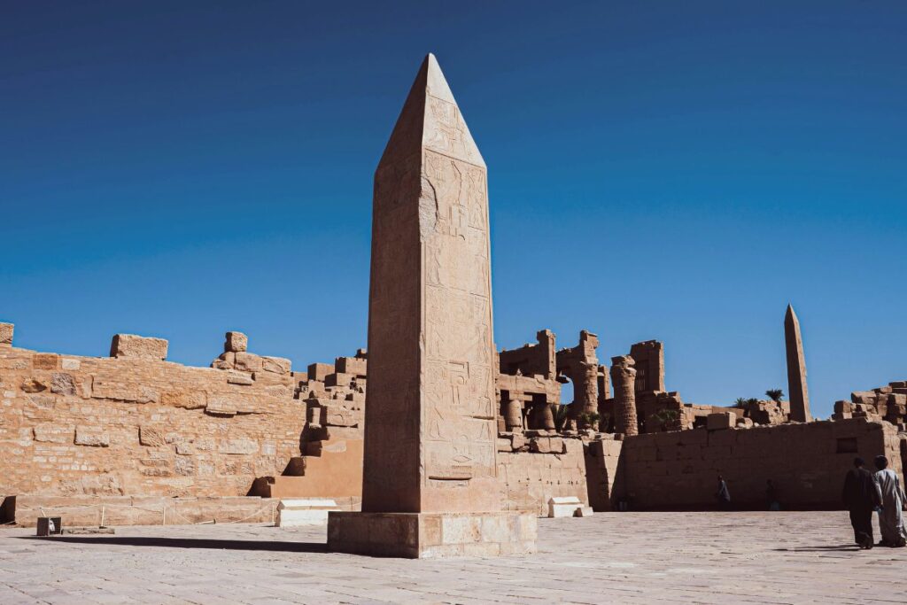 Stunning view of the Great Sphinx of Giza with the Pyramids in the background under a bright blue sky in Egypt