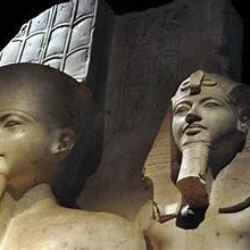 Two grand statues of ancient Egyptian pharaohs, symbolizing power and divinity.Tomb Of General Horemheb