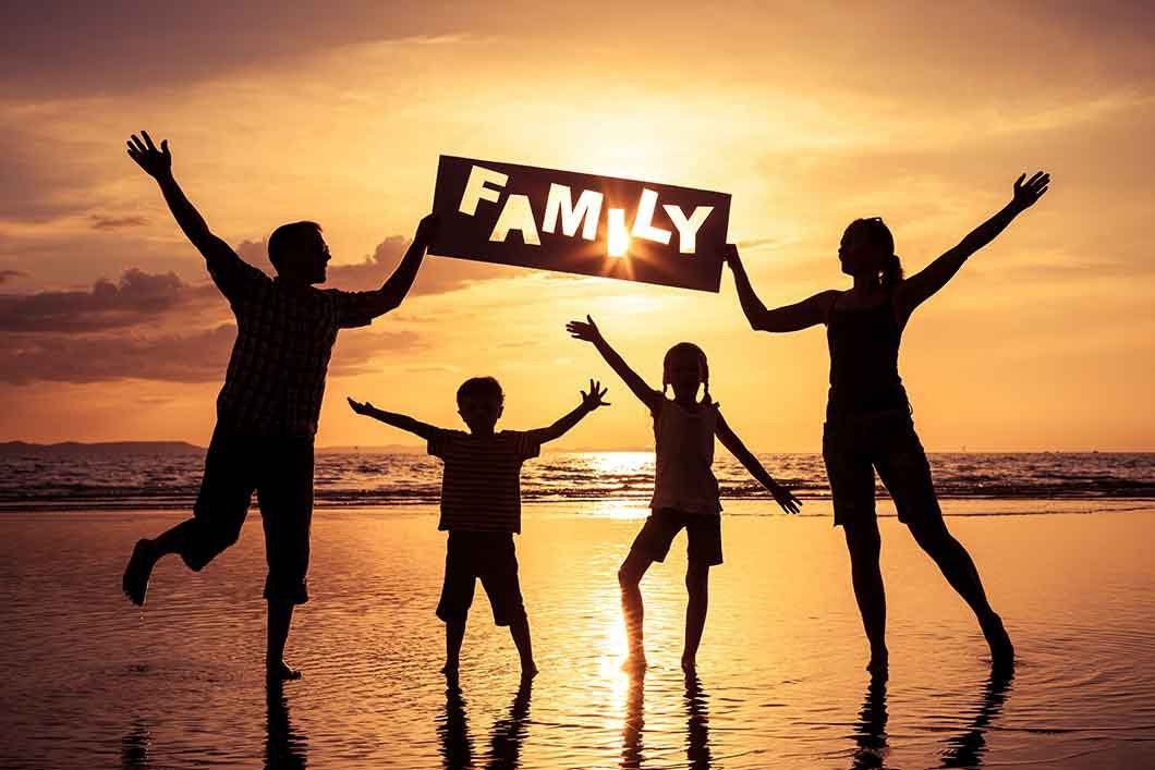Happy family enjoying a fun day at a beautiful beach in Egypt, with golden sand, clear blue water, and a sunny sky