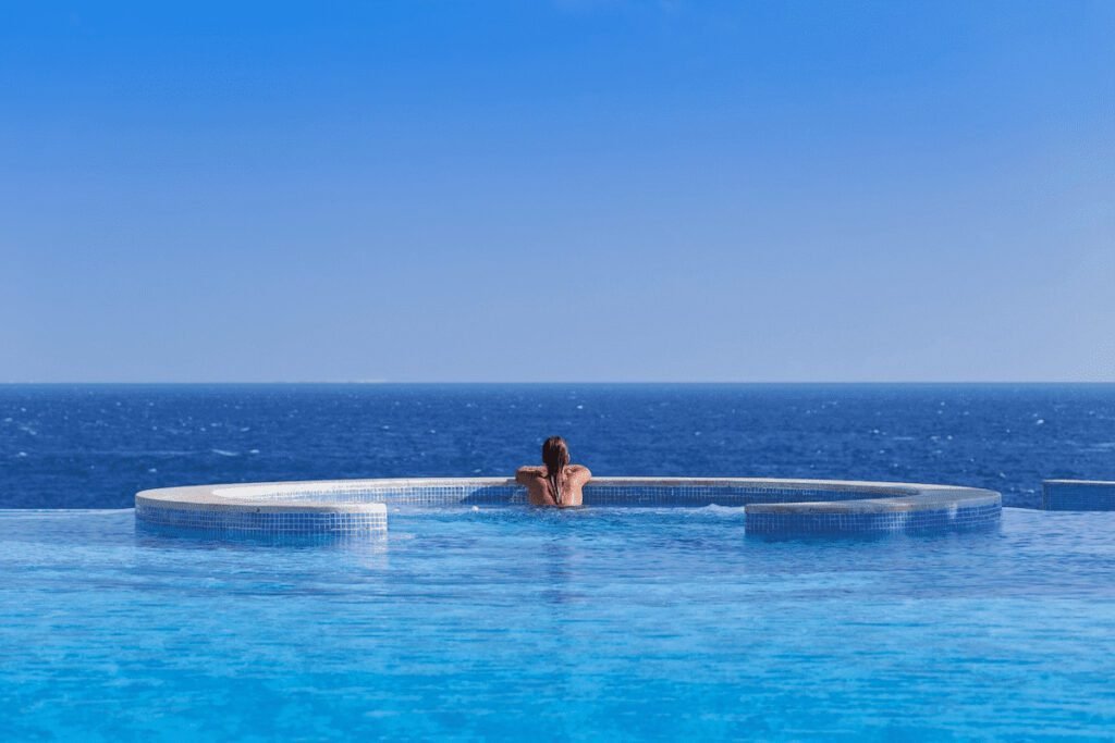 The Oberoi Sahl Hasheesh, a luxury resort in Hurghada, Egypt, featuring a stunning infinity pool overlooking the Red Sea and elegant architectural design