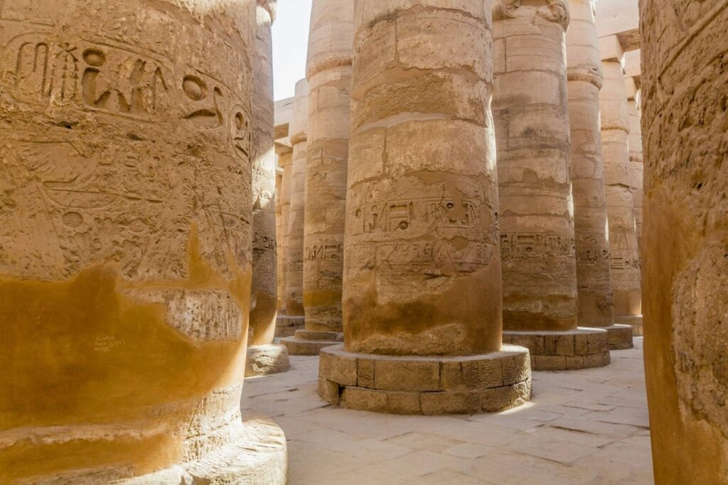 Carved stone columns in the Karnak Temple, Luxor, Egypt.