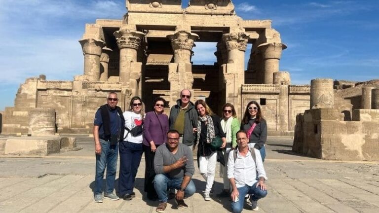 A group of tourists posing in front of the ancient Kom Ombo Temple in Egypt