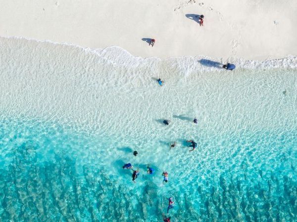 A serene aerial view of Marsa Alam's pristine beach with turquoise waters and a sandy shoreline