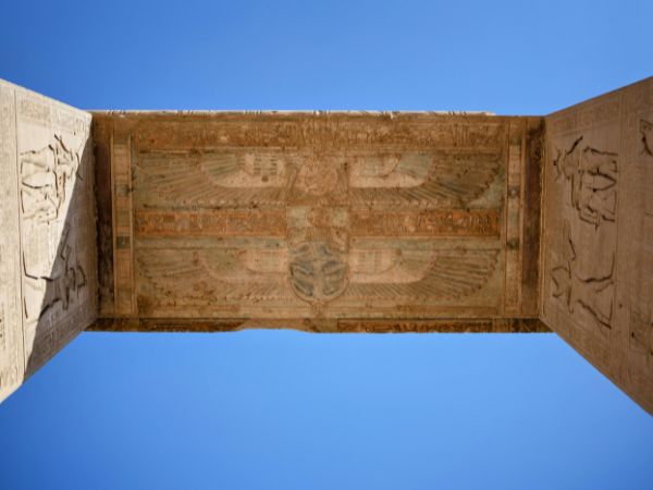 The intricately carved ceiling of an ancient Egyptian temple, featuring detailed patterns and symbols