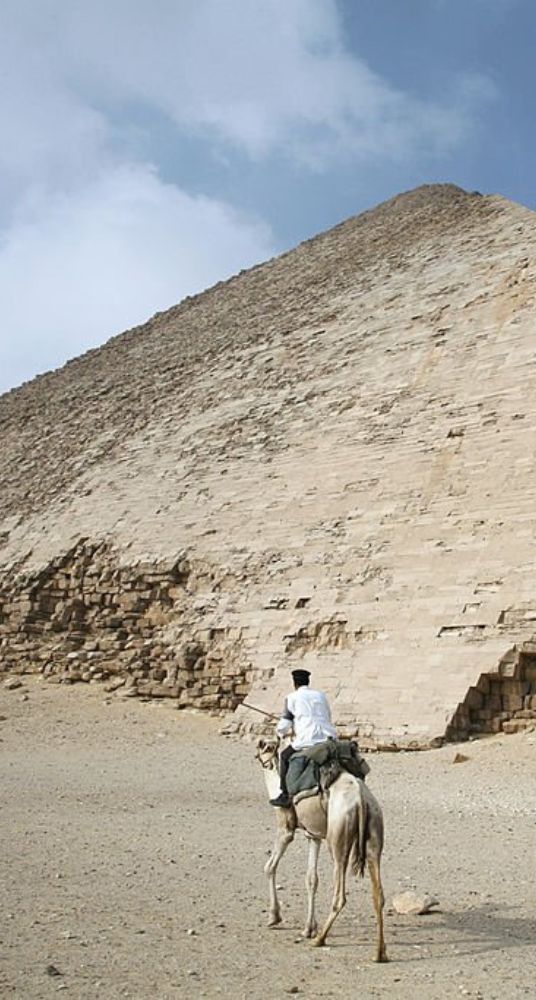 The Red Pyramid of Dahshur in Egypt surrounded by a vast desert landscape