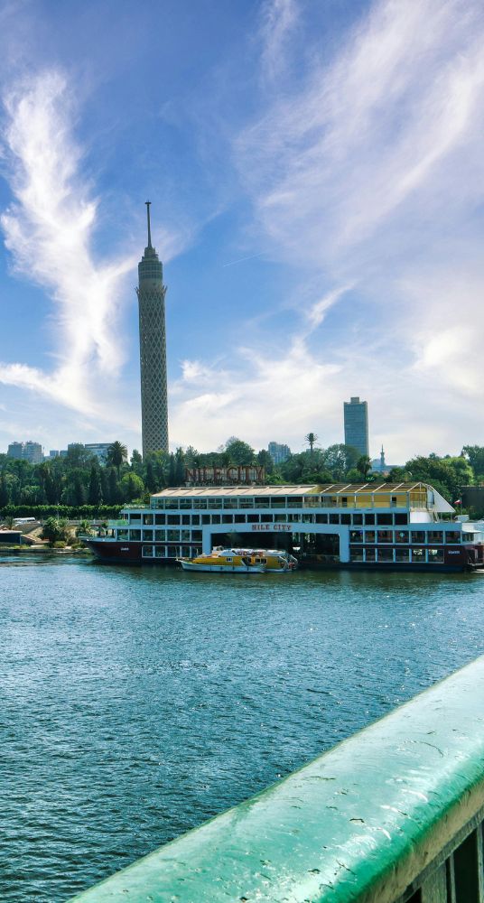 Elegant dinner cruise on the Nile River with a well-decorated table and a scenic view of Cairo at night