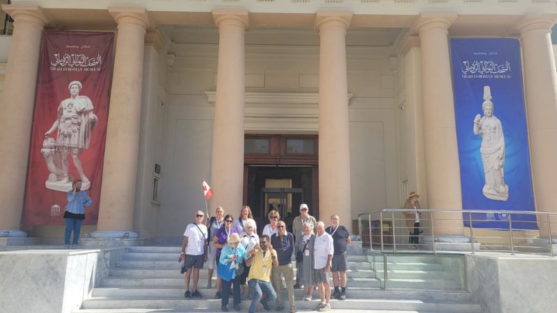 A group of tourists standing in front of the Greco-Roman Museum in Alexandria, Egypt