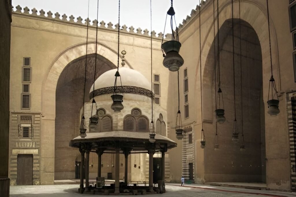 ablution fountain under hanging lamps inside mosque courtyard
