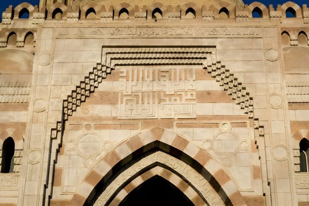 intricate stone carving above islamic gate in cairo