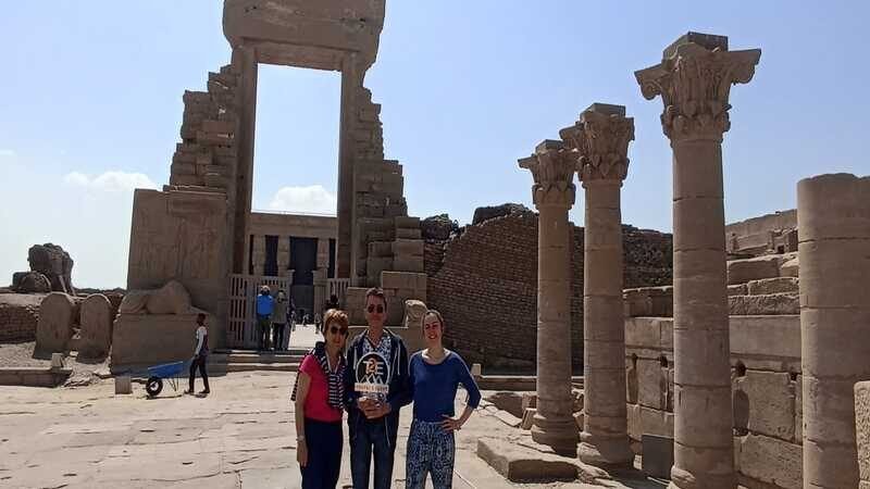 Tourists standing among ancient columns at Kom Ombo Temple in Egypt