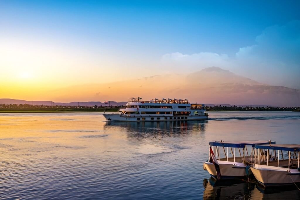 luxury nile cruise ship sailing on the river at sunset in Egypt