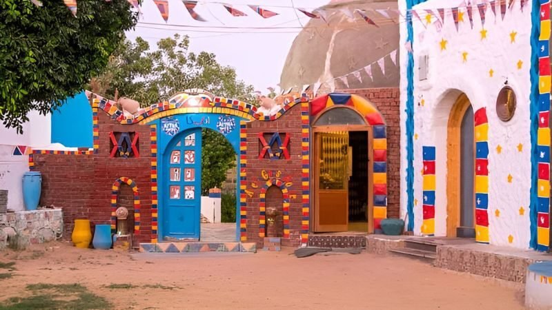 Nubian village with brightly painted houses and domed roofs under clear sky