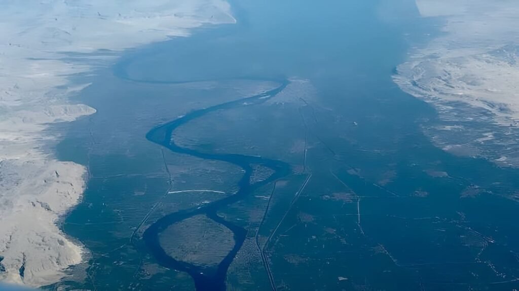 Aerial view of the River Nile winding through lush green land and desert