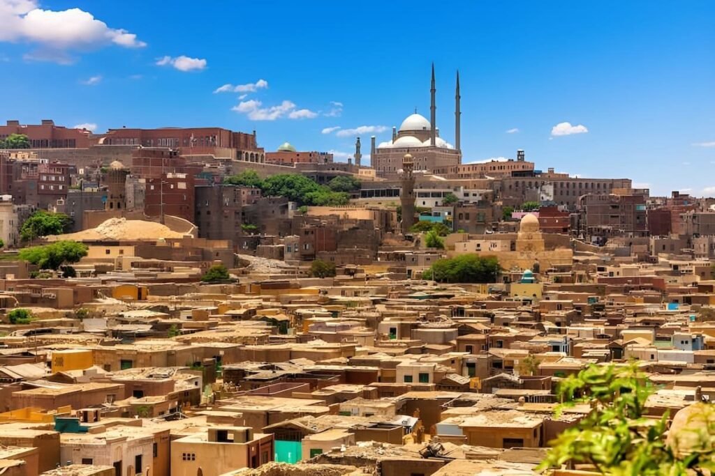 Aerial view of Saladin Citadel golden stone fortress and mosques under warm light