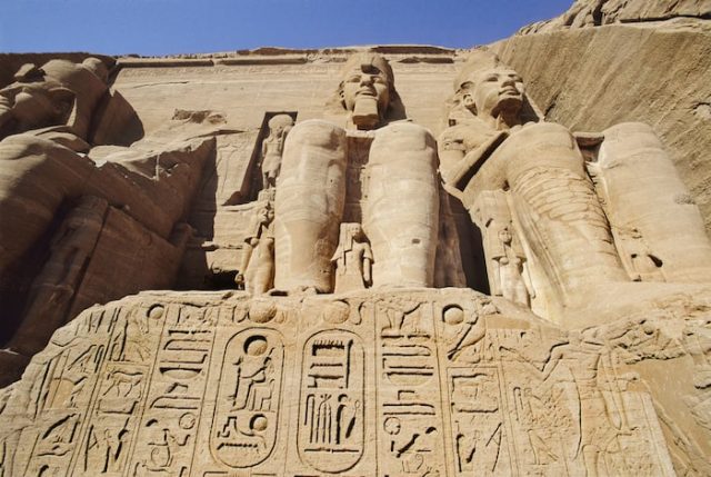 Upward view of the towering Ramses II statues at Abu Simbel.